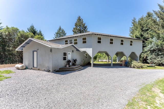 32211 Condor Rd, Willits, CA 95490 - view of front facade featuring a carport, stucco siding, and gravel driveway
