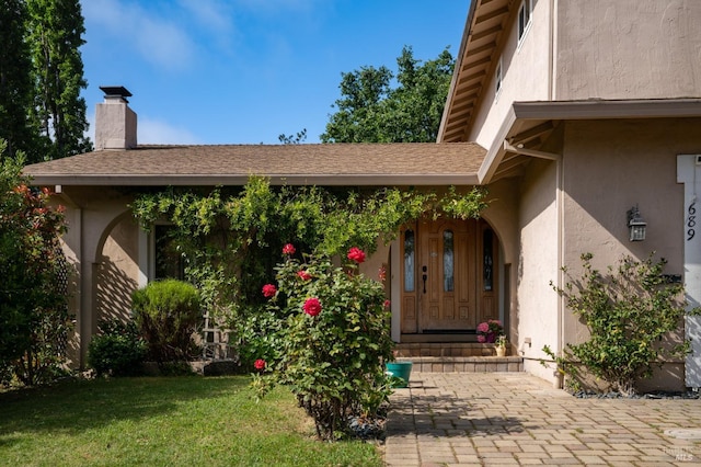 689 Rio Vista Dr, Napa, CA 94558 - property entrance with stucco siding, a lawn, and a chimney