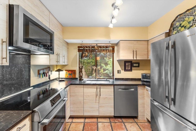822 2nd St W, Sonoma, CA 95476 - kitchen featuring light brown cabinetry, dark stone counters, a sink, a toaster, and appliances with stainless steel finishes