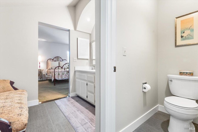 822 2nd St W, Sonoma, CA 95476 - bathroom featuring lofted ceiling, toilet, vanity, connected bathroom, and baseboards