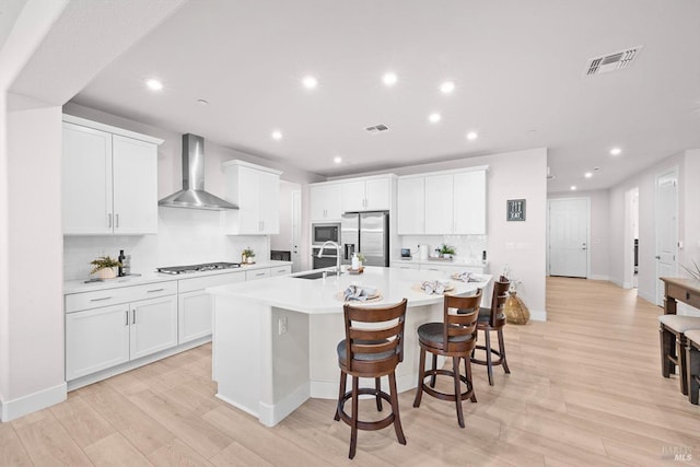 1532 Base Ct, Dixon, CA 95620 - kitchen with a sink, wall chimney exhaust hood, stainless steel fridge with ice dispenser, a large island with sink, and gas cooktop