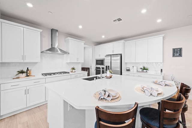 1532 Base Ct, Dixon, CA 95620 - kitchen featuring a sink, wall chimney range hood, gas cooktop, built in microwave, and stainless steel fridge with ice dispenser