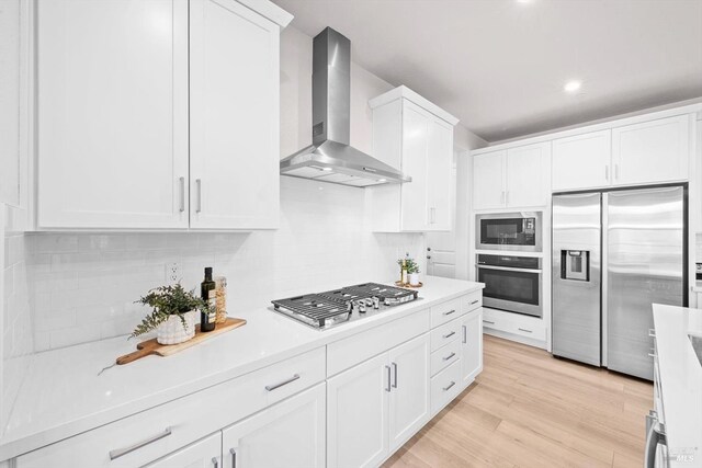 1532 Base Ct, Dixon, CA 95620 - kitchen featuring tasteful backsplash, wall chimney exhaust hood, white cabinetry, light countertops, and appliances with stainless steel finishes