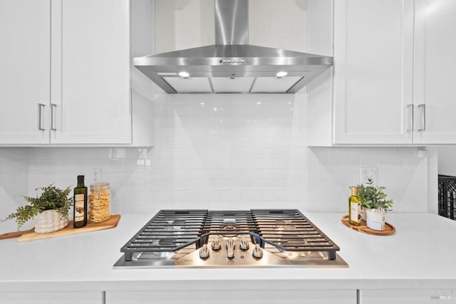 1532 Base Ct, Dixon, CA 95620 - kitchen featuring wall chimney range hood, white cabinetry, stainless steel gas stovetop, and light countertops