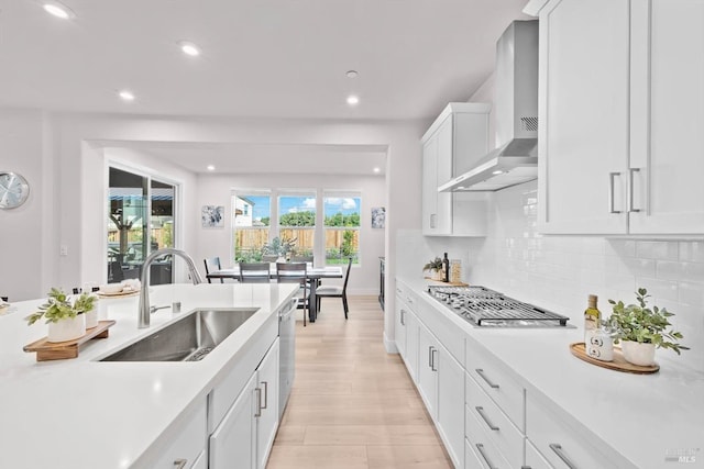 1532 Base Ct, Dixon, CA 95620 - kitchen with a sink, stainless steel appliances, wall chimney exhaust hood, light countertops, and decorative backsplash