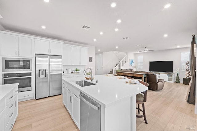 1532 Base Ct, Dixon, CA 95620 - kitchen featuring a sink, stainless steel appliances, white cabinets, visible vents, and light countertops