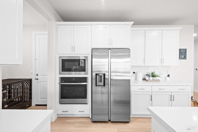 1532 Base Ct, Dixon, CA 95620 - kitchen featuring light countertops, stainless steel appliances, and white cabinets