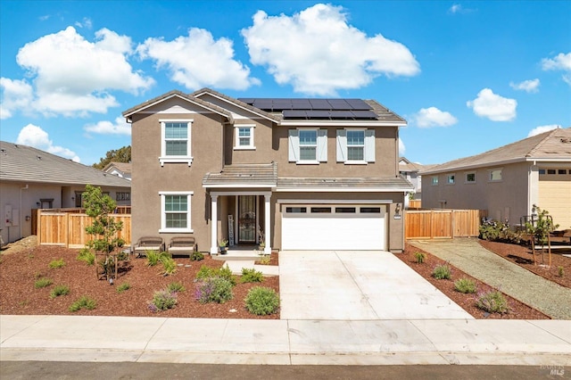 1532 Base Ct, Dixon, CA 95620 - view of front facade with fence, an attached garage, driveway, stucco siding, and roof mounted solar panels