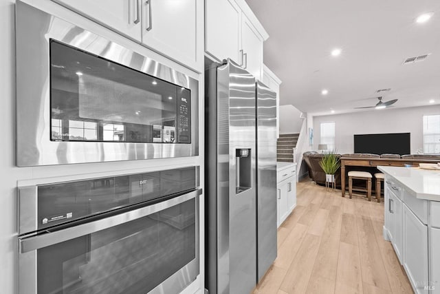 1532 Base Ct, Dixon, CA 95620 - kitchen with white cabinetry, light countertops, a ceiling fan, and appliances with stainless steel finishes