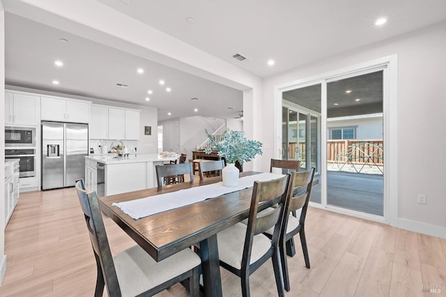 1532 Base Ct, Dixon, CA 95620 - dining room featuring light wood-type flooring, recessed lighting, stairway, and visible vents