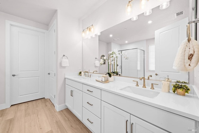 1532 Base Ct, Dixon, CA 95620 - full bath featuring a sink, double vanity, a shower stall, and wood finished floors