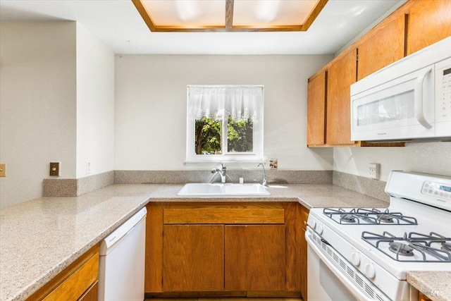kitchen with light countertops, brown cabinetry, a sink, and white appliances