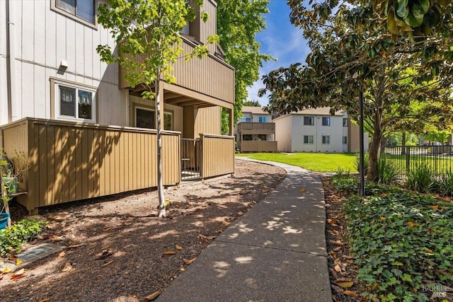 exterior space with fence and a balcony