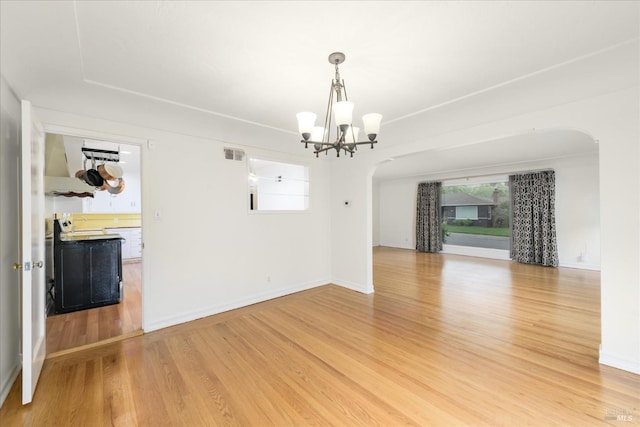 1361 Mariposa St, Vallejo, CA 94590 - unfurnished room featuring arched walkways, a chandelier, and light wood finished floors