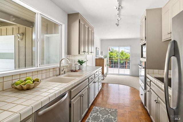 15 Junipero Serra Ave, San Rafael, CA 94901 - kitchen featuring appliances with stainless steel finishes, a sink, tile countertops, tasteful backsplash, and gray cabinetry