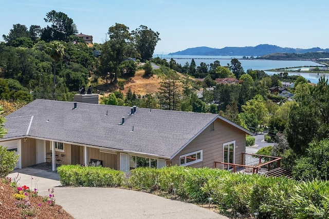 15 Junipero Serra Ave, San Rafael, CA 94901 - view of front of home with a deck with water view, a chimney, and board and batten siding