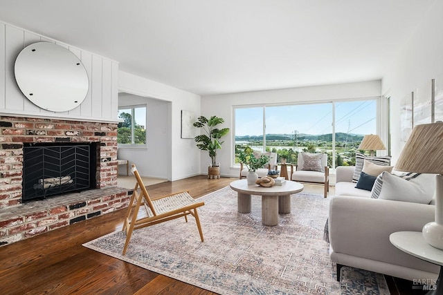 15 Junipero Serra Ave, San Rafael, CA 94901 - living room featuring wood finished floors, a brick fireplace, and baseboards