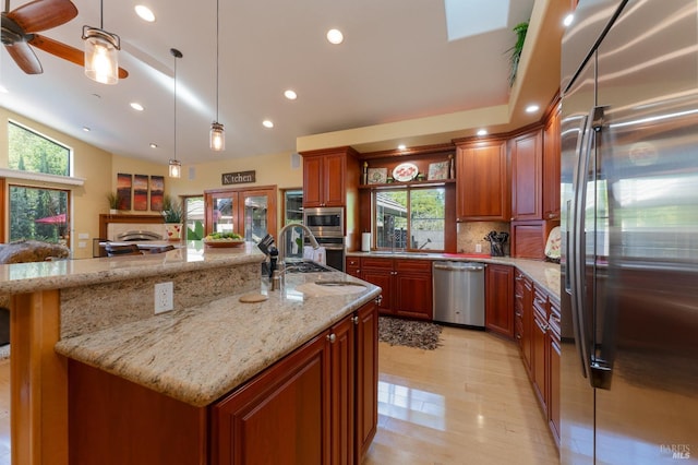 kitchen featuring recessed lighting, a healthy amount of sunlight, appliances with stainless steel finishes, and a sink