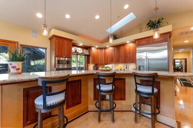 kitchen with built in appliances, light stone counters, visible vents, decorative backsplash, and light wood-style floors