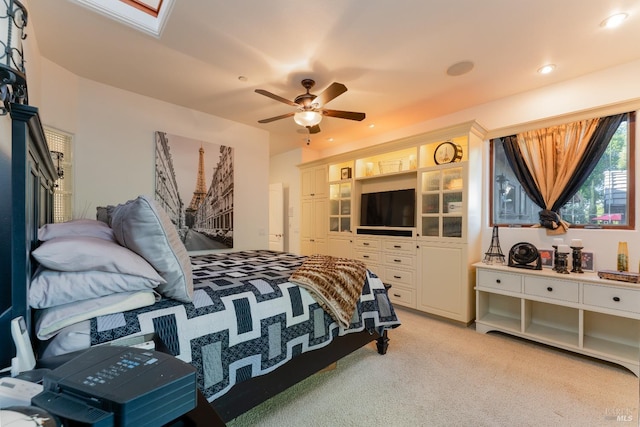 bedroom featuring a ceiling fan, light carpet, a skylight, and recessed lighting