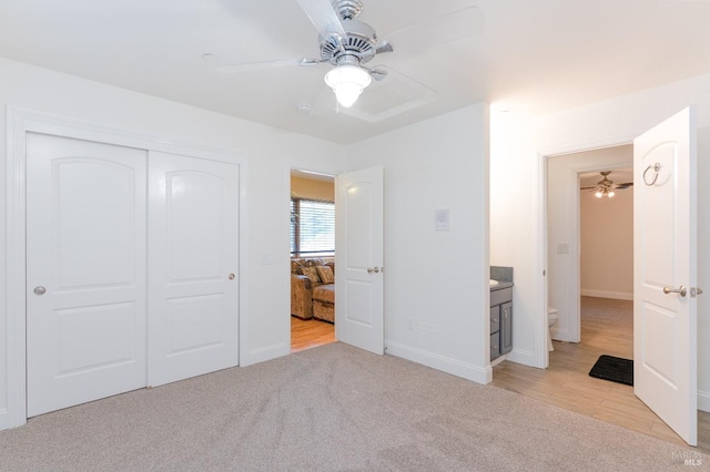 unfurnished bedroom featuring baseboards, a closet, a ceiling fan, and carpet floors
