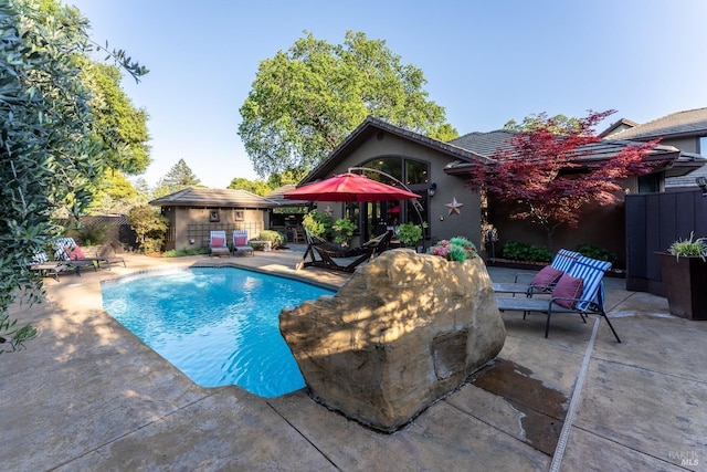 view of swimming pool featuring fence, a patio, and a fenced in pool