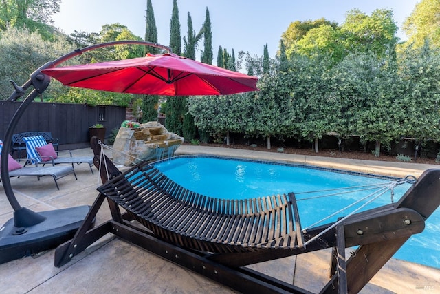 view of pool with a patio, a fenced in pool, and fence