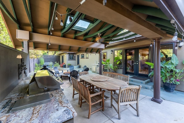 view of patio with fence, french doors, and outdoor dining space