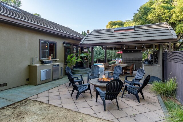 doorway to property with stucco siding, fence, and a patio