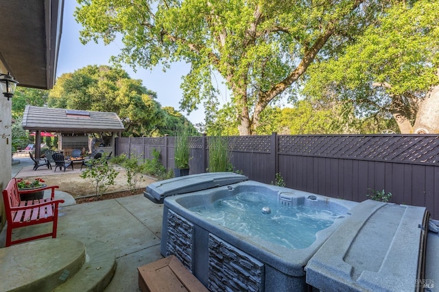 view of patio / terrace with a hot tub and a fenced backyard