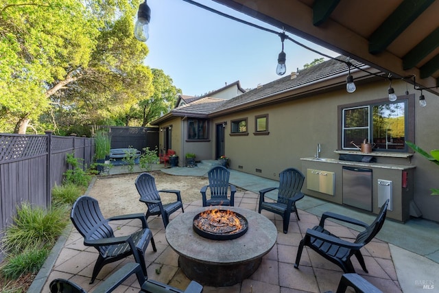view of patio / terrace with an outdoor fire pit and a fenced backyard
