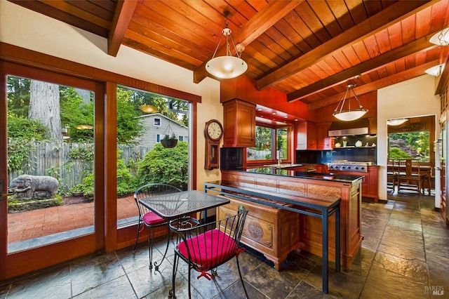 2300 S St, Eureka, CA 95501 - kitchen featuring stone tile floors, wood ceiling, dark countertops, and hanging light fixtures