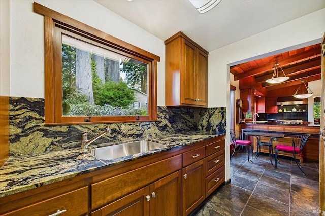 2300 S St, Eureka, CA 95501 - kitchen with backsplash, a sink, dark stone finish flooring, dark stone countertops, and stainless steel gas cooktop