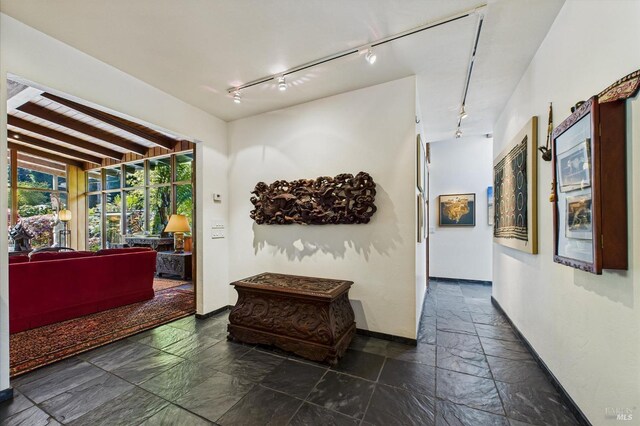 2300 S St, Eureka, CA 95501 - hallway featuring rail lighting, baseboards, and stone tile flooring