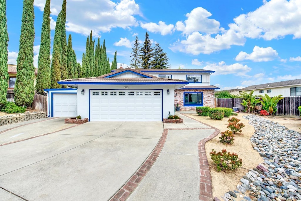 1649 Foothill Pl, Fairfield, CA 94534 - view of front of house with concrete driveway, a garage, and fence