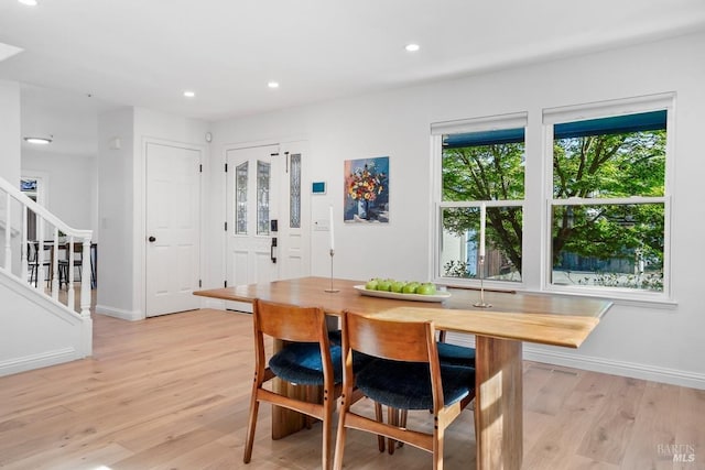 dining room with stairs, baseboards, recessed lighting, and light wood-style floors