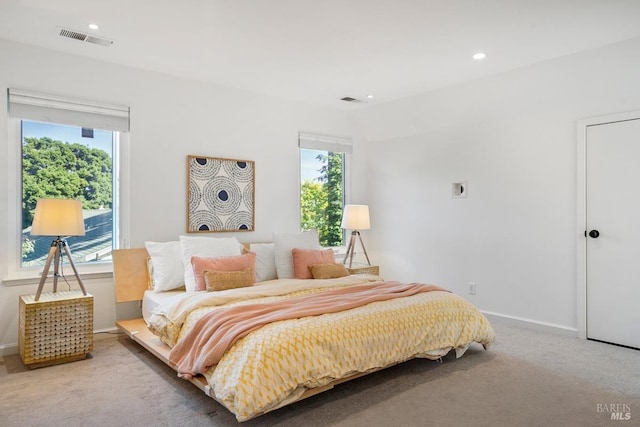 carpeted bedroom featuring visible vents, baseboards, and recessed lighting
