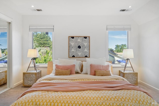 bedroom with light colored carpet, visible vents, baseboards, and recessed lighting