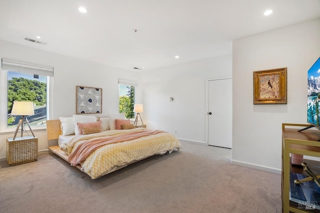 bedroom with baseboards, multiple windows, carpet flooring, and visible vents