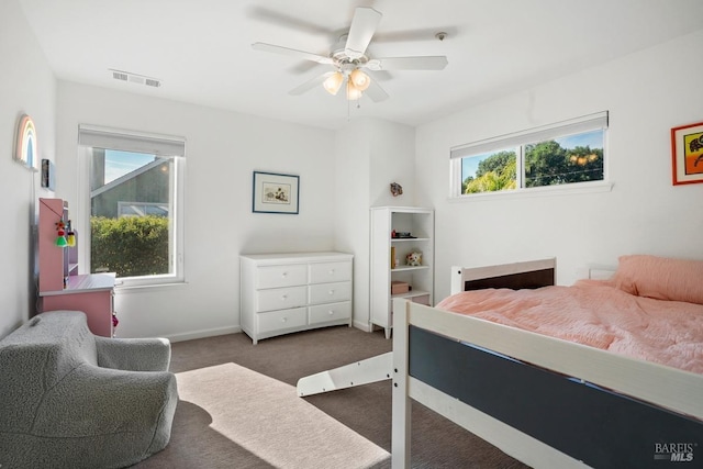 bedroom with a ceiling fan, baseboards, visible vents, and carpet