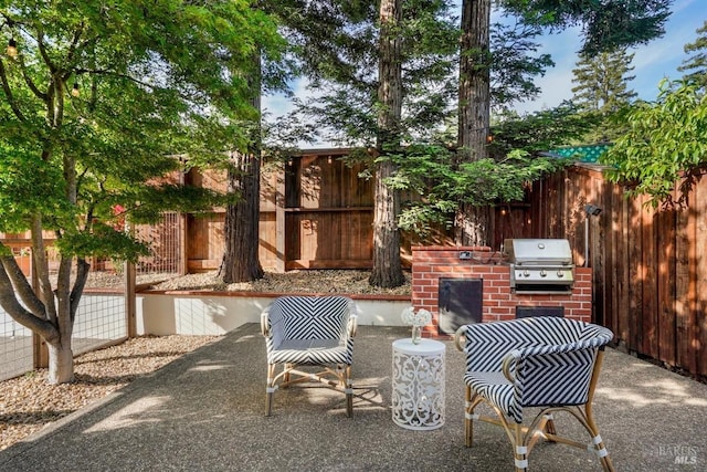 view of patio with fence and area for grilling