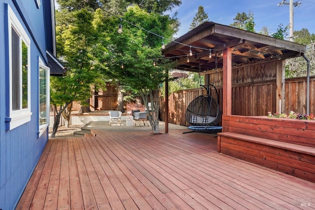 wooden terrace featuring a fenced backyard