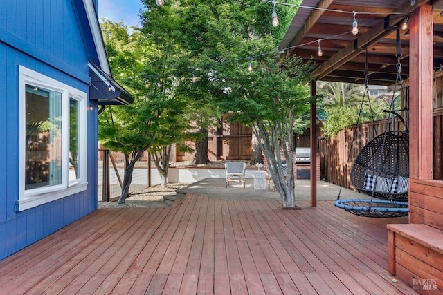 wooden deck featuring a fenced backyard and grilling area