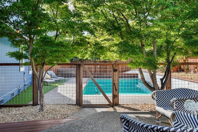 view of pool with fence, a fenced in pool, and a patio area