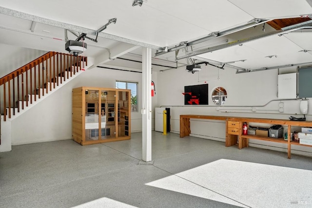 garage with a workshop area and a garage door opener