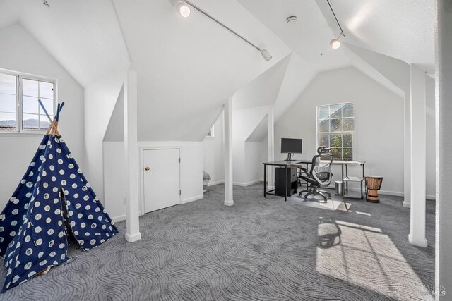 home office featuring rail lighting, vaulted ceiling, baseboards, and carpet floors