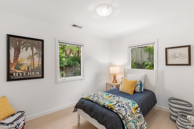 bedroom with wood finished floors and baseboards