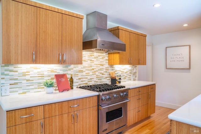 7301 Baker Ln, Sebastopol, CA 95472 - kitchen with designer stove, wall chimney range hood, light wood-style floors, light countertops, and recessed lighting