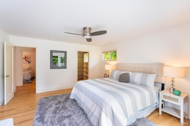7301 Baker Ln, Sebastopol, CA 95472 - bedroom featuring light wood finished floors, a ceiling fan, a walk in closet, and baseboards