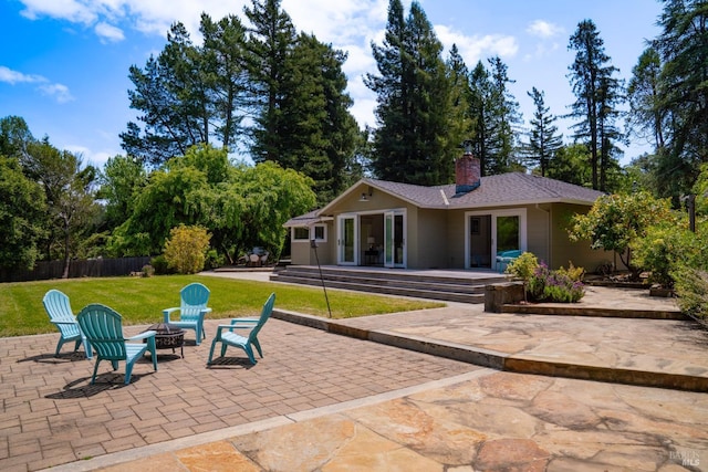 7301 Baker Ln, Sebastopol, CA 95472 - back of property featuring an outdoor fire pit, a patio, a chimney, and roof with shingles